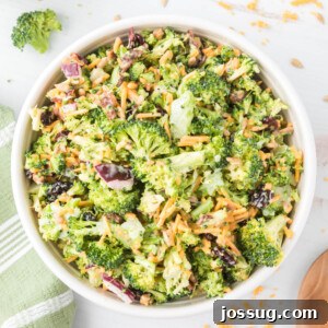 A top-down view into a bowl filled with classic broccoli salad, showcasing a perfect mix of fresh ingredients and creamy dressing.