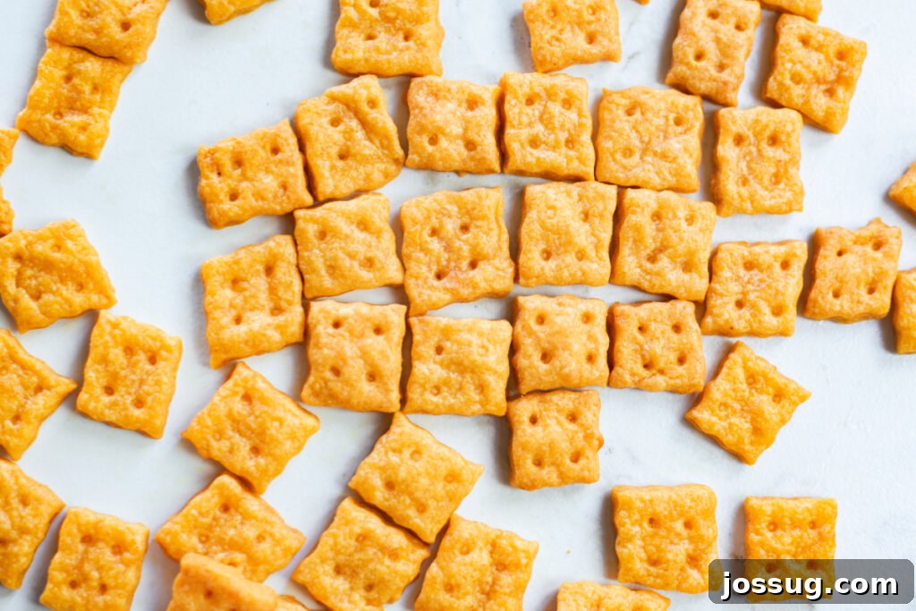 Cheesy Bites 5 A generous scattering of homemade cheese crackers on a white surface, invitingly golden and textured.