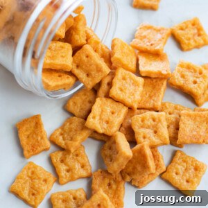 Cheesy Bites 6 A glass jar overflowing with crispy homemade cheese crackers.