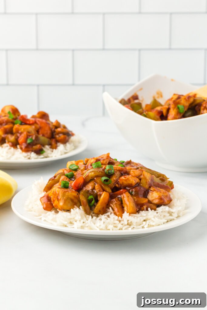 Close-up of a plate of vibrant Hawaiian Chicken, featuring tender chicken pieces, colorful bell peppers, and juicy pineapple, ready to be enjoyed.