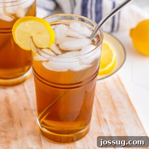 Long Island Iced Tea in glass, garnished with lemon