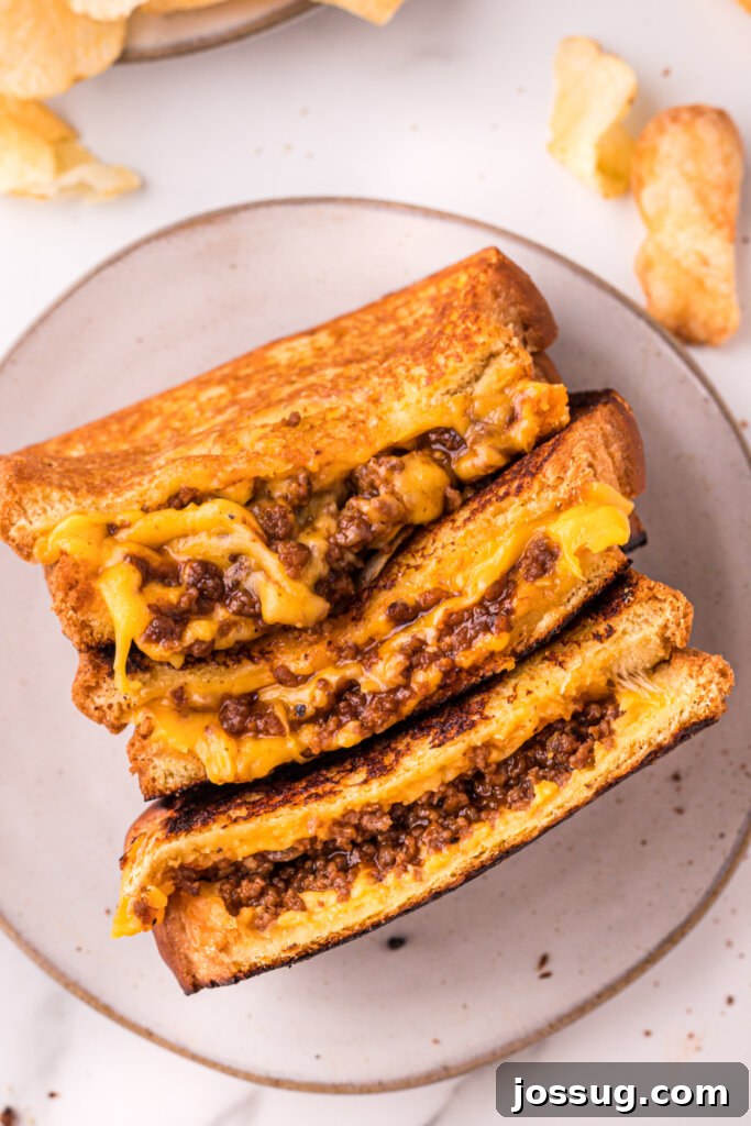 Sloppy Joe Meltdown 3 A plate featuring three halves of Sloppy Joe Grilled Cheese, perfectly golden and ready to eat.
