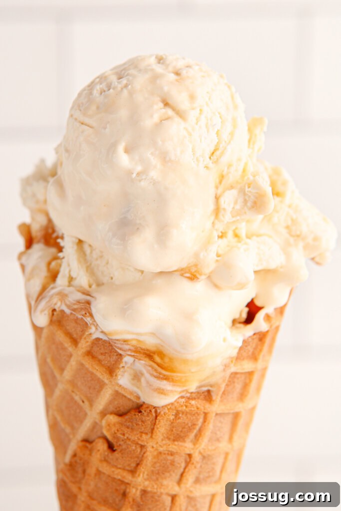 Scoop of No-Churn Salted Caramel Ice Cream in a crispy waffle cone, ready to be enjoyed.