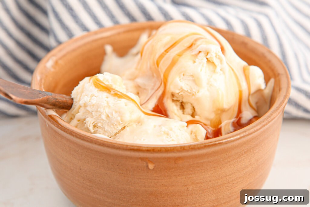 A bowl of creamy salted caramel ice cream with a spoon, showing off its rich color and inviting swirls.