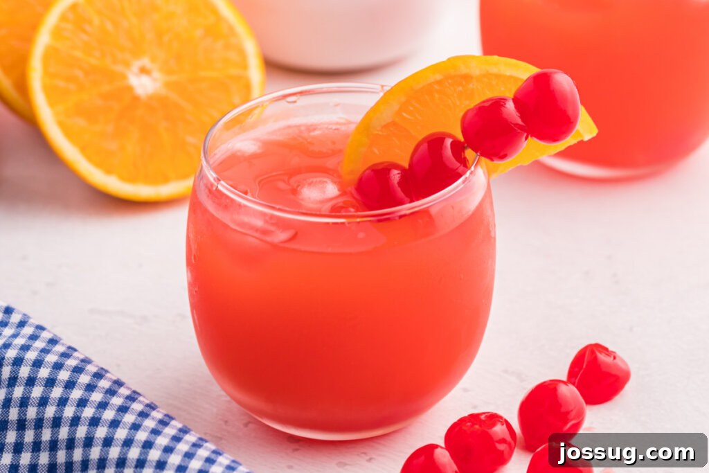 Starlet's Sweet Sparkle 5 shirley temple punch mocktail garnished with cherries and orange slice