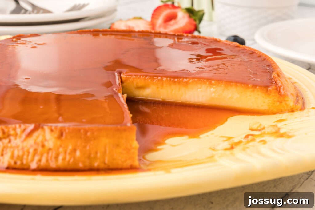 Velvety Caramel Flan 5 A glorious Spanish flan with a piece already enjoyed, showing the inviting caramel and creamy custard.