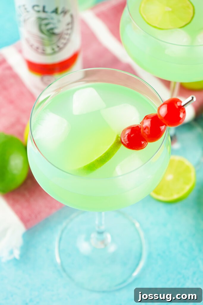 Marine Dream Elixir 2 Looking down into a glass with a vibrant Tipsy Mermaid Cocktail, garnished with fruit.