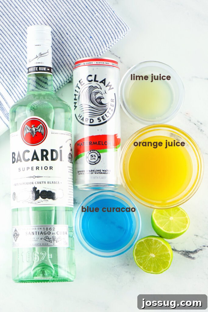 Marine Dream Elixir 3 Ingredients laid out on a table to make the Tipsy Mermaid Cocktail, including rum, blue curaçao, pineapple juice, and lime juice.