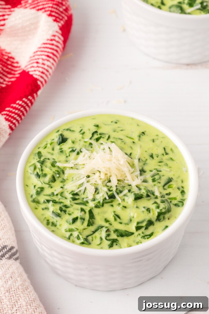 Gourmet Spinach Gratin 3 A bowl of easy creamed spinach, beautifully topped with grated Parmesan cheese, ready to serve.