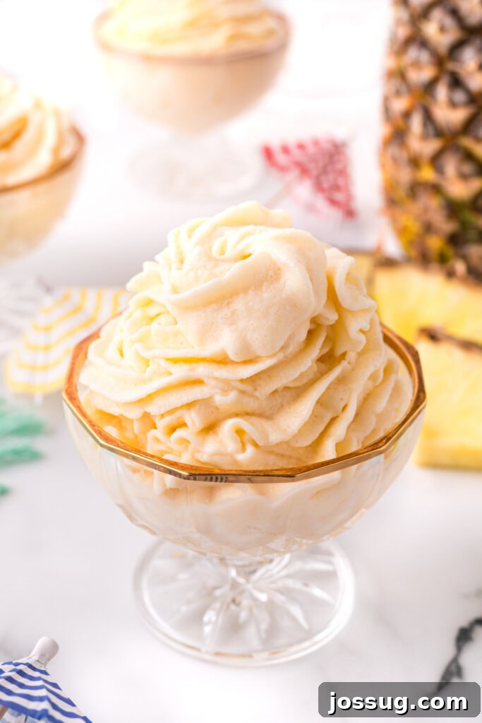 copycat disney dole whip in glass bowl, garnished with pineapple
