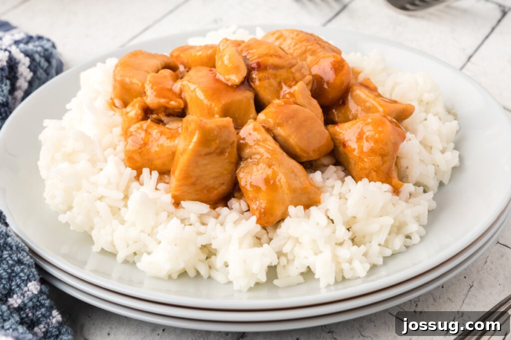 Velvet Bourbon Chicken 5 Platter of Bourbon Chicken served over rice, ready to be enjoyed.