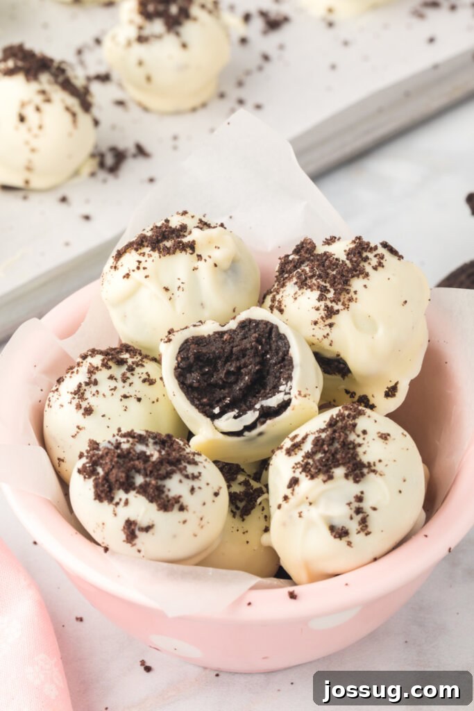 Delicious Oreo truffles perfectly arranged in a bowl, showcasing their irresistible appeal as a simple, no-bake dessert.