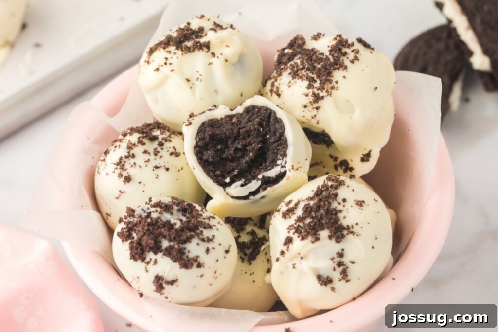 A single Oreo truffle resting delicately in a bowl, showcasing its smooth candy coating and inviting texture.