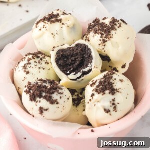 Oreo truffles arranged neatly in a vibrant pink bowl, highlighting their attractive presentation.