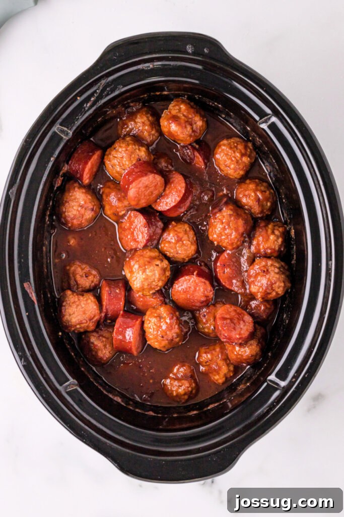 Sweet and Smoky Cranberry Chipotle Meatball and Sausage Duet 3 Cranberry Chipotle Meatballs and Sausage simmering in a slow cooker