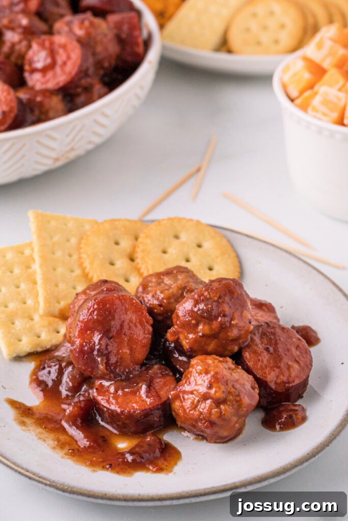 Sweet and Smoky Cranberry Chipotle Meatball and Sausage Duet 4 Cranberry Chipotle Meatballs and Sausage served on a plate with crackers for an appetizer