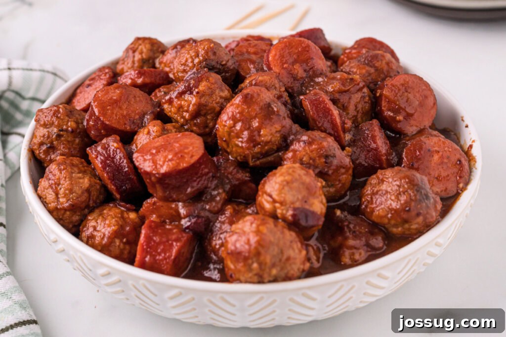 Sweet and Smoky Cranberry Chipotle Meatball and Sausage Duet 5 Cooked Cranberry Chipotle Meatballs and Sausage in a white bowl, ready to enjoy