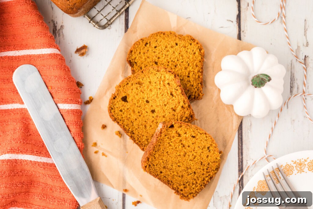 Cozy Pumpkin Spice Bread 5 Three perfectly sliced pieces of pumpkin bread, beautifully presented on a serving platter.