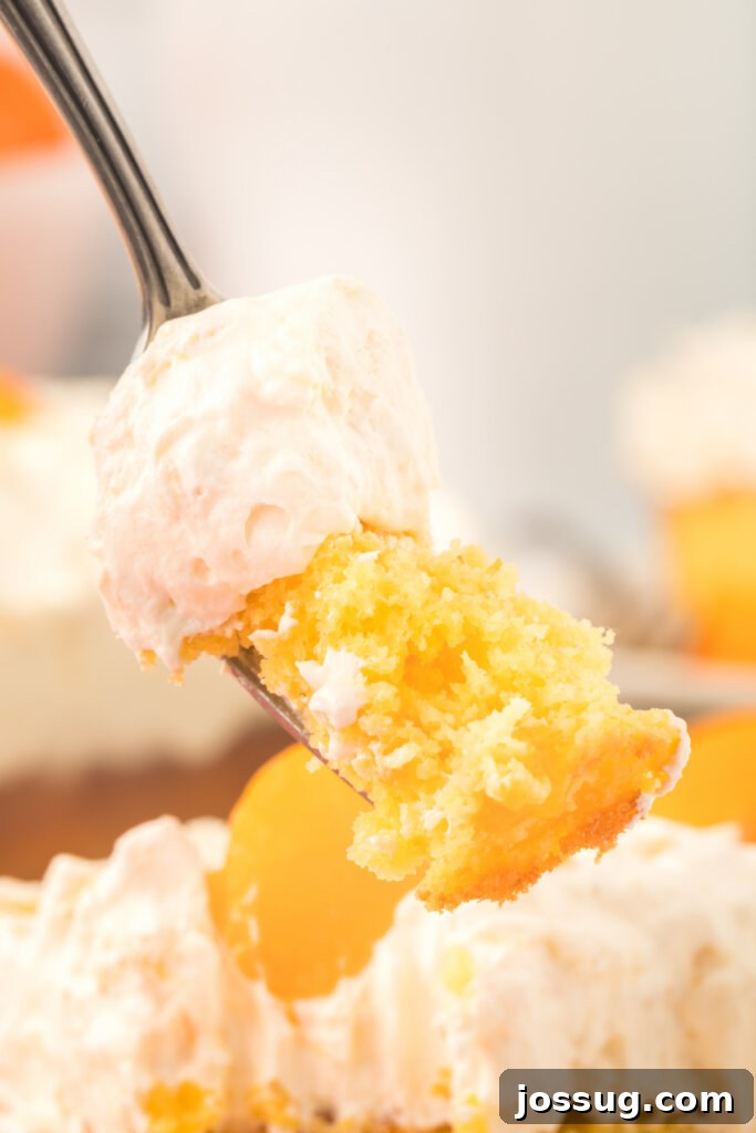 A fork holding a bite of Pig Pickin' Cake, showing the airy frosting and moist cake.