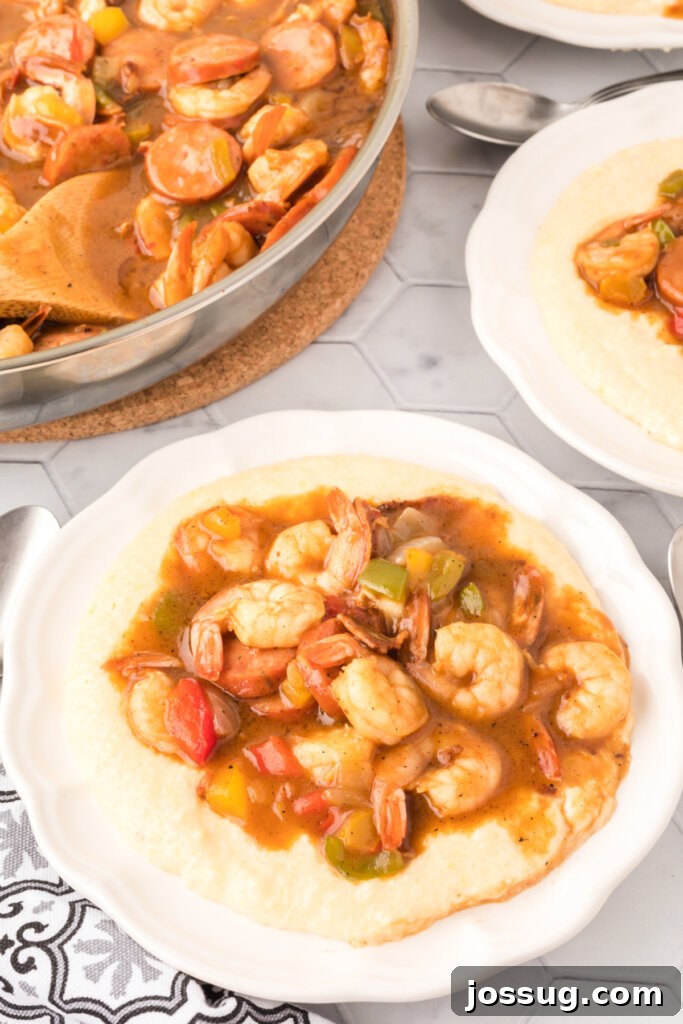 Carolina's Signature Shrimp and Grits 2 A beautifully presented plate of Carolina Shrimp and Grits, garnished and ready to serve.