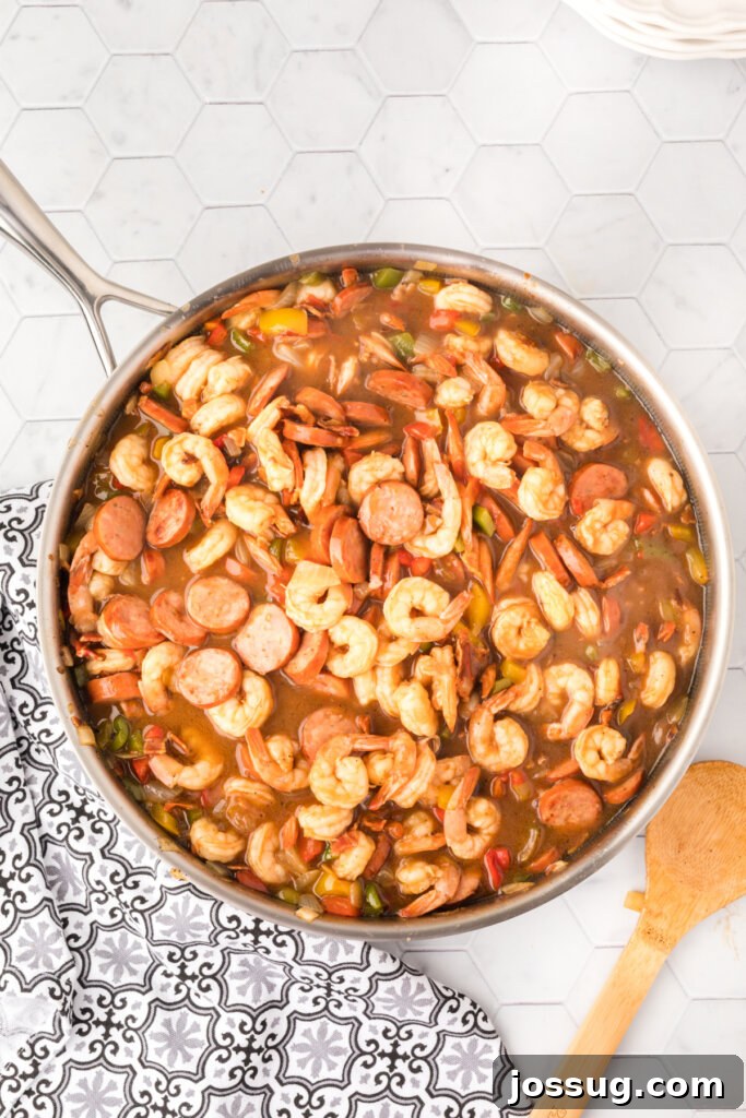 Carolina's Signature Shrimp and Grits 3 A cast-iron skillet filled with the savory shrimp and sausage mixture, ready to be served over grits.