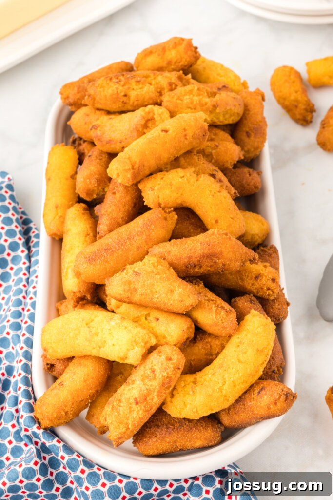 Signature Eastern NC Hush Puppies 2 A golden basket filled with freshly fried Eastern NC Hush Puppies, ready to be served