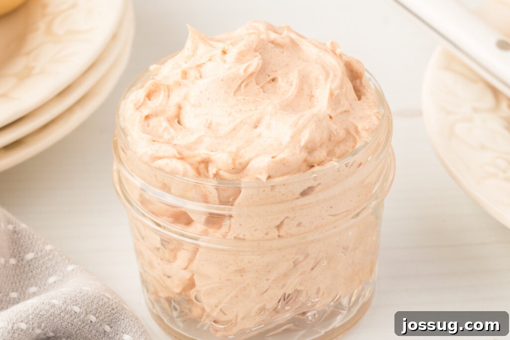 Freshly prepared cinnamon butter in a glass jar, demonstrating its light, fluffy, and perfectly mixed appearance