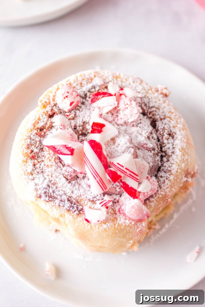 looking down onto a candy cane cinnamon roll on a plate