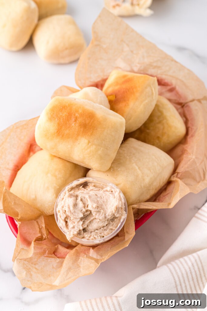 copycat texas roadhouse rolls in basket with cinnamon butter