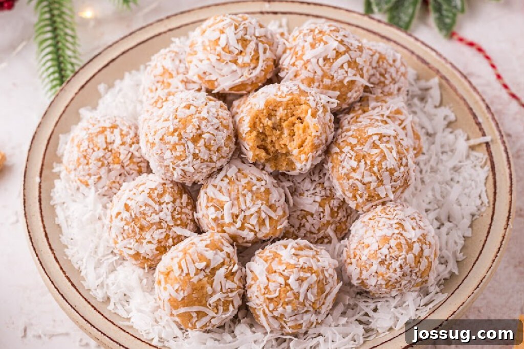 Coconut Bliss Bites 6 A large pile of coconut snowballs on a white plate, showcasing their inviting texture