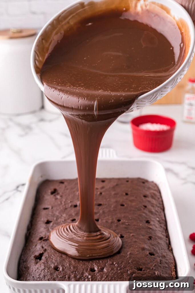 Peppermint Dream Poke Cake 3 pouring the chocolate filling over the poked cake