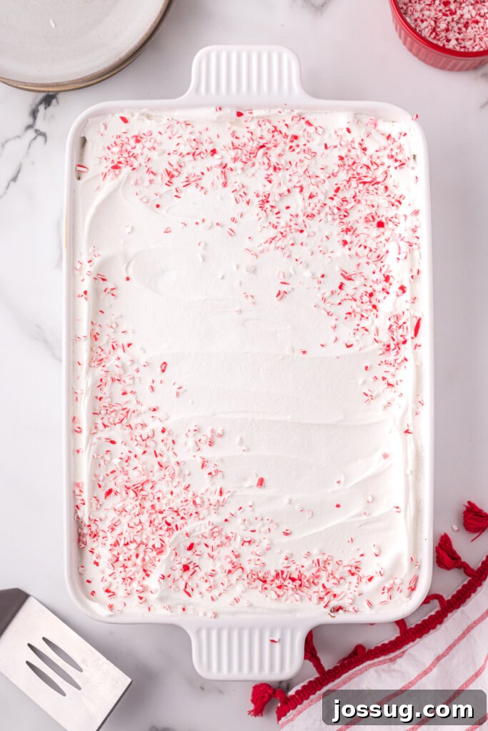 Peppermint Dream Poke Cake 5 peppermint pieces on top of the cake