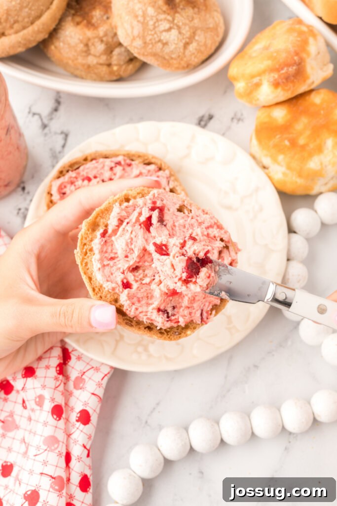 Crimson Cranberry Cloud Butter 4 Whipped cranberry butter spread generously over a toasted English muffin, ready to be enjoyed.