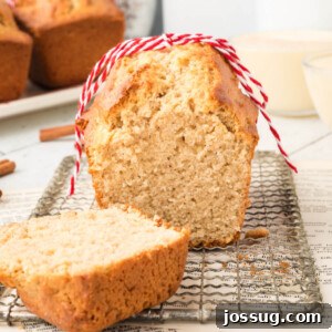 A freshly cut slice of golden Holiday Eggnog Bread, showing its tender crumb and inviting texture.