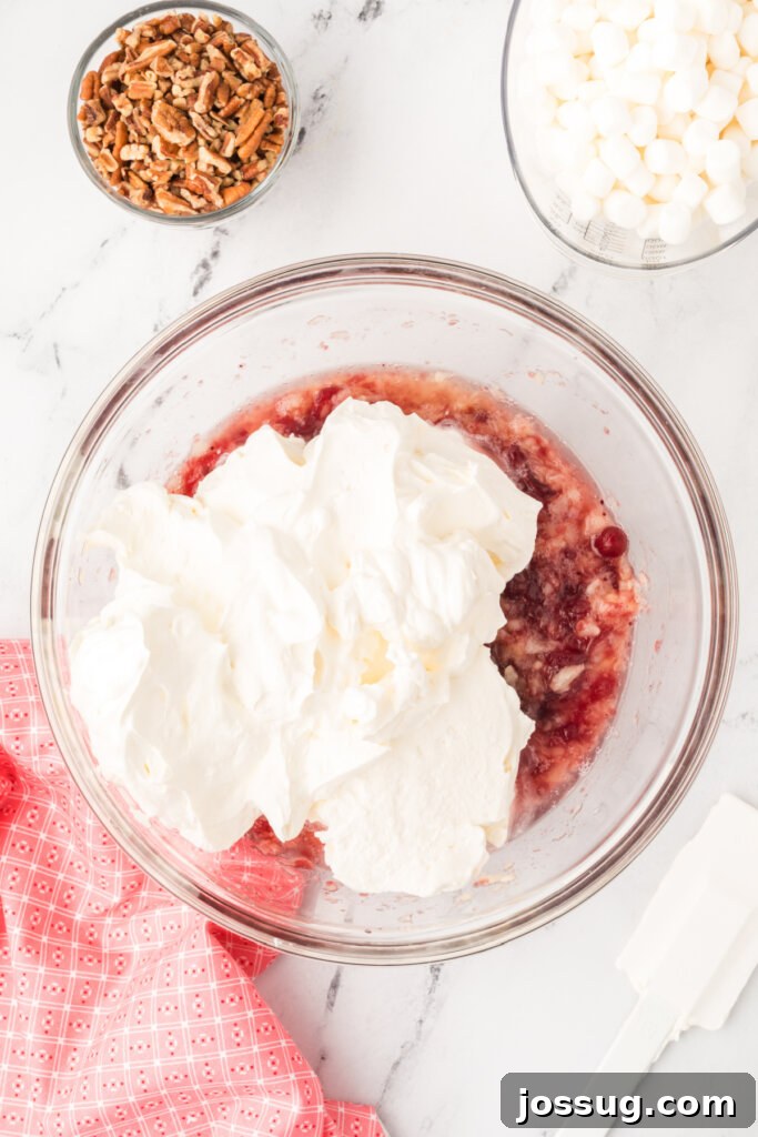 fold the whipped topping mixture into the cranberry mixture