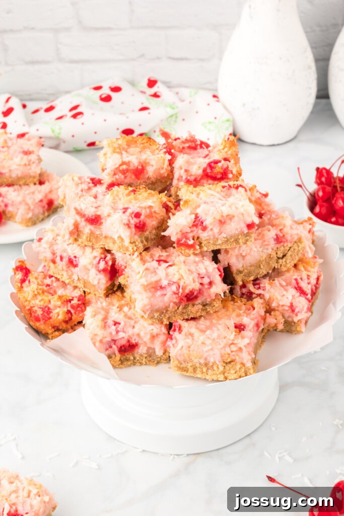 Cherry Coconut Magic Bars beautifully arranged on a white cake plate.