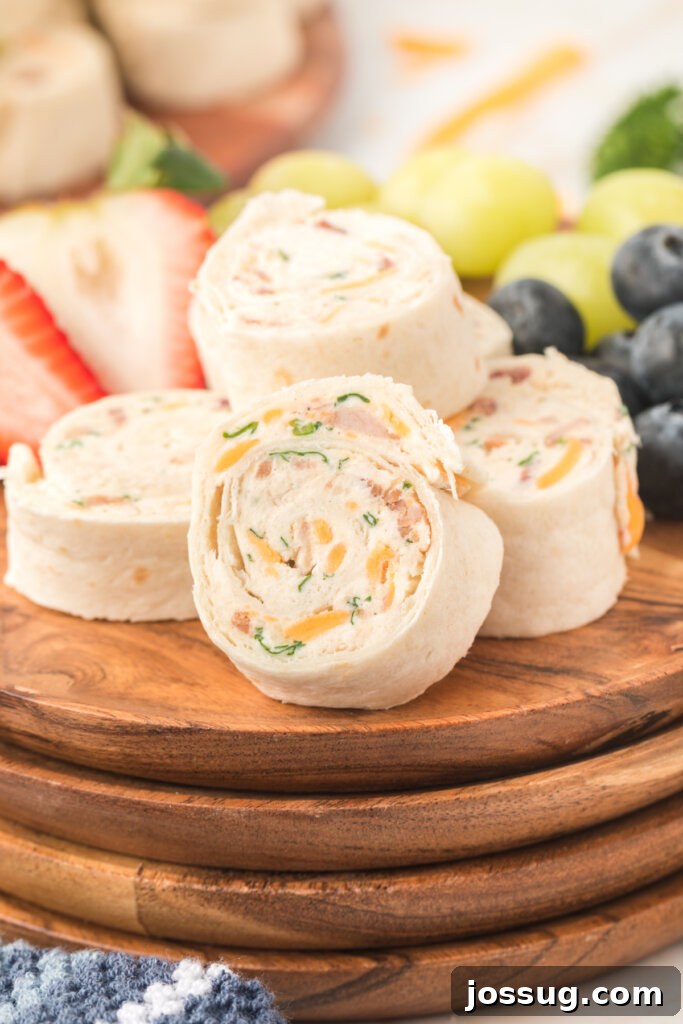 Creamy Chicken Bacon Ranch Pinwheels 2 chicken bacon ranch pinwheels on wooden plates