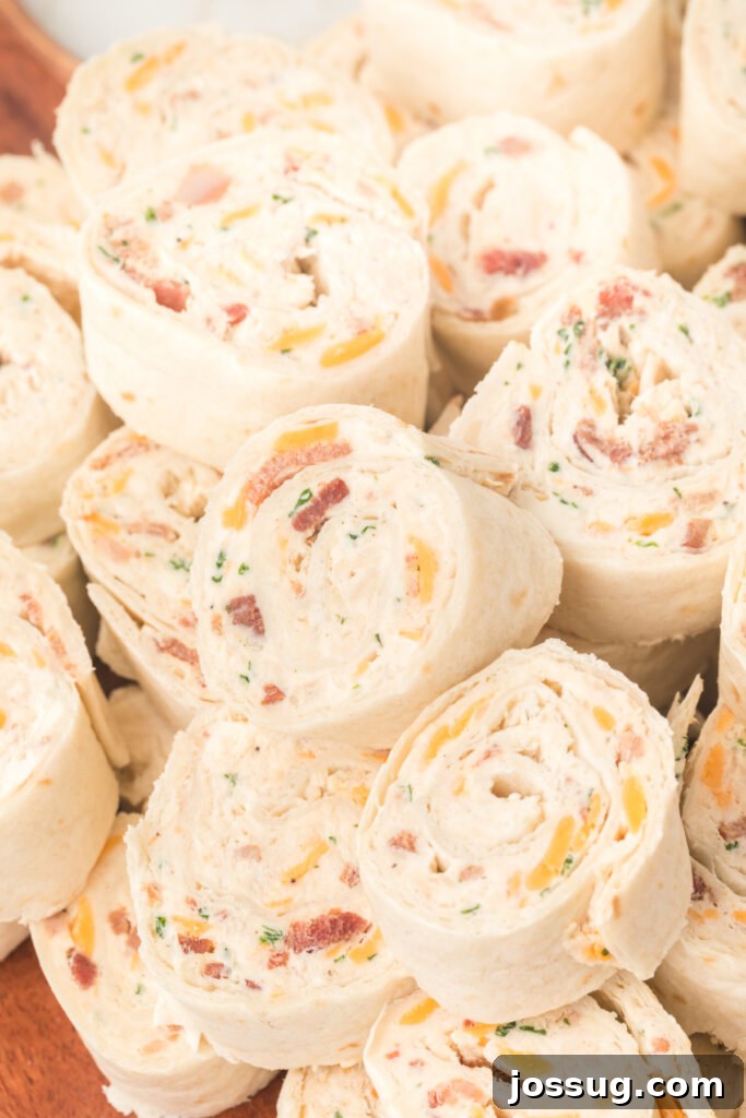 Creamy Chicken Bacon Ranch Pinwheels 3 chicken bacon ranch tortilla roll-ups stacked on top of each other
