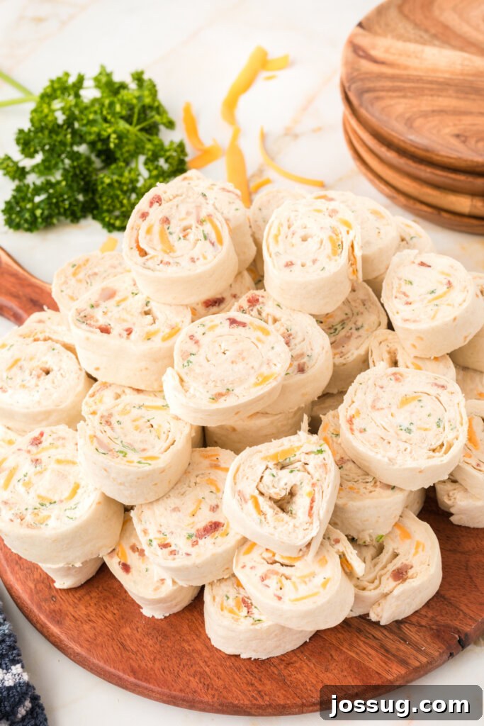 Creamy Chicken Bacon Ranch Pinwheels 5 christmas appetizers on wooden board