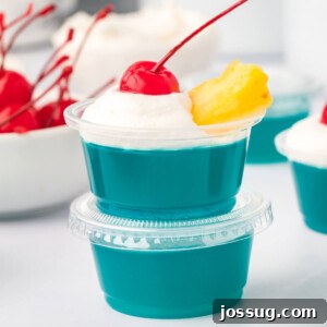 Two vibrant blue Hawaiian jello shots, stacked for a playful presentation, ready to be enjoyed.