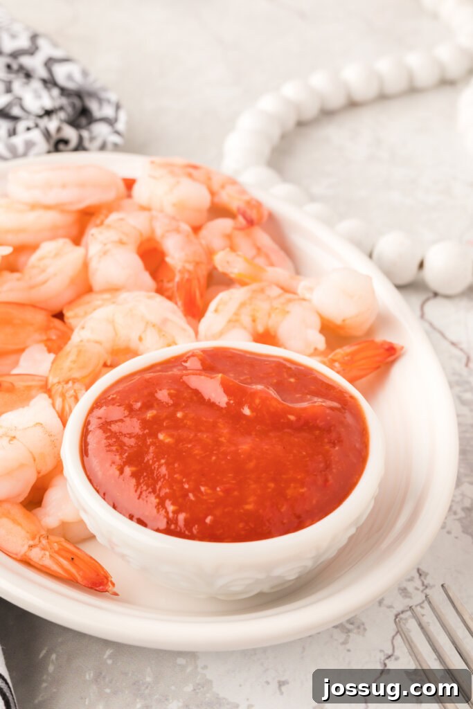 shrimp and shrimp cocktail sauce on white serving platter