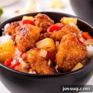 Close-up of Copycat Sweet Fire Chicken, emphasizing the glossy sauce and perfectly cooked ingredients.