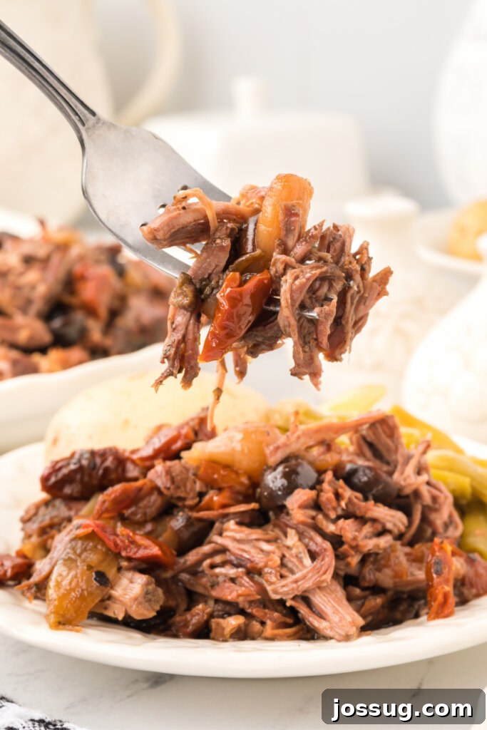 Mediterranean Sunshine Slow Cooker Pot Roast 5 italian pot roast scooped off plate onto fork