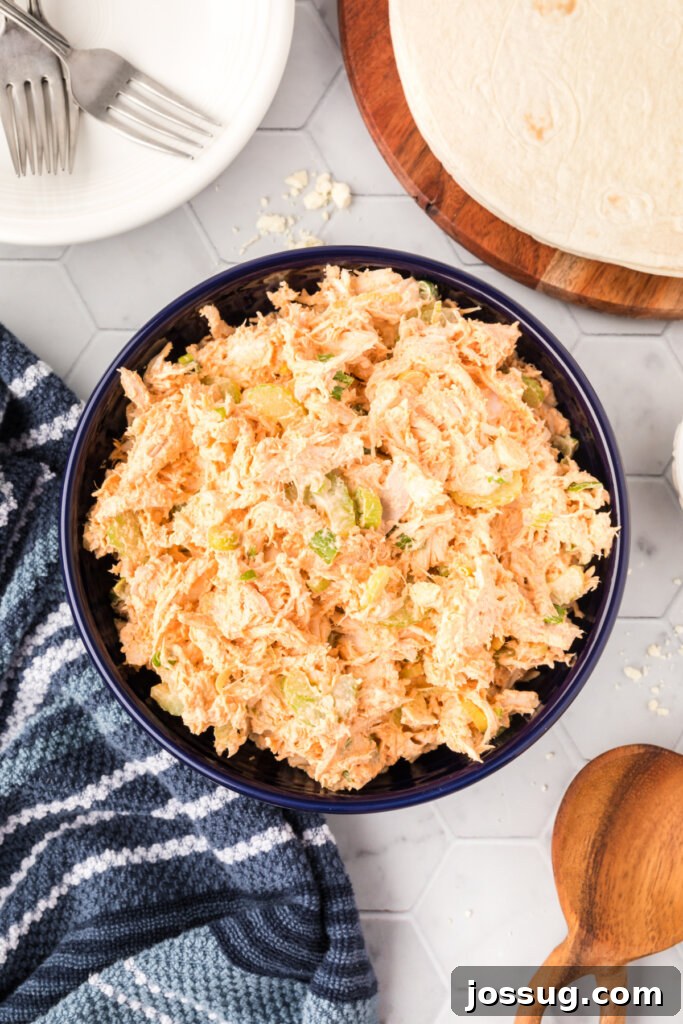 bowl filled with buffalo chicken salad, garnished with green onion