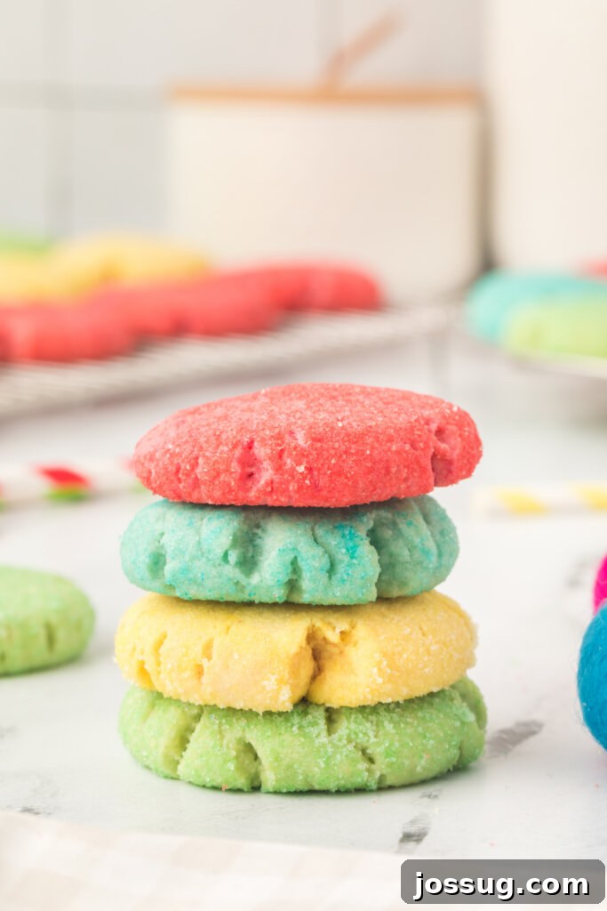 Stacked red, blue, yellow, and green Jello cookies showcasing their vibrant colors and chewy texture