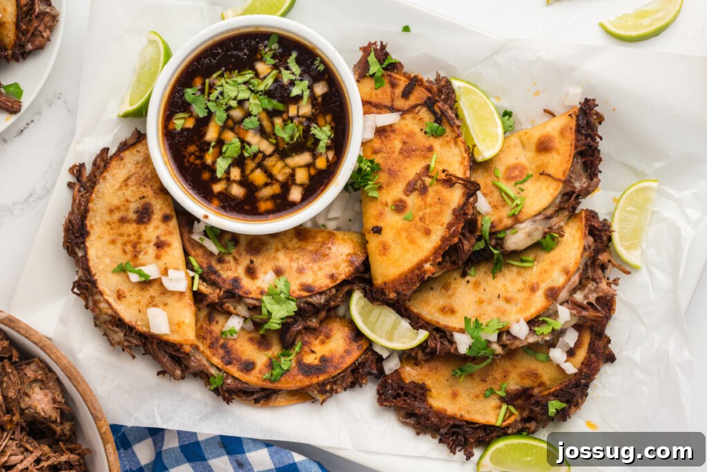Overhead shot of a platter filled with freshly made birria tacos
