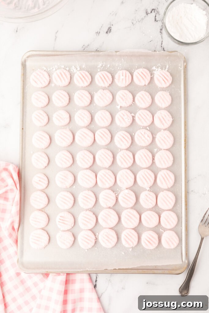 Velvet Mint Bites 4 Freshly shaped cream cheese mints drying neatly on waxed paper on a baking sheet, indicating they are in the crucial setting stage.