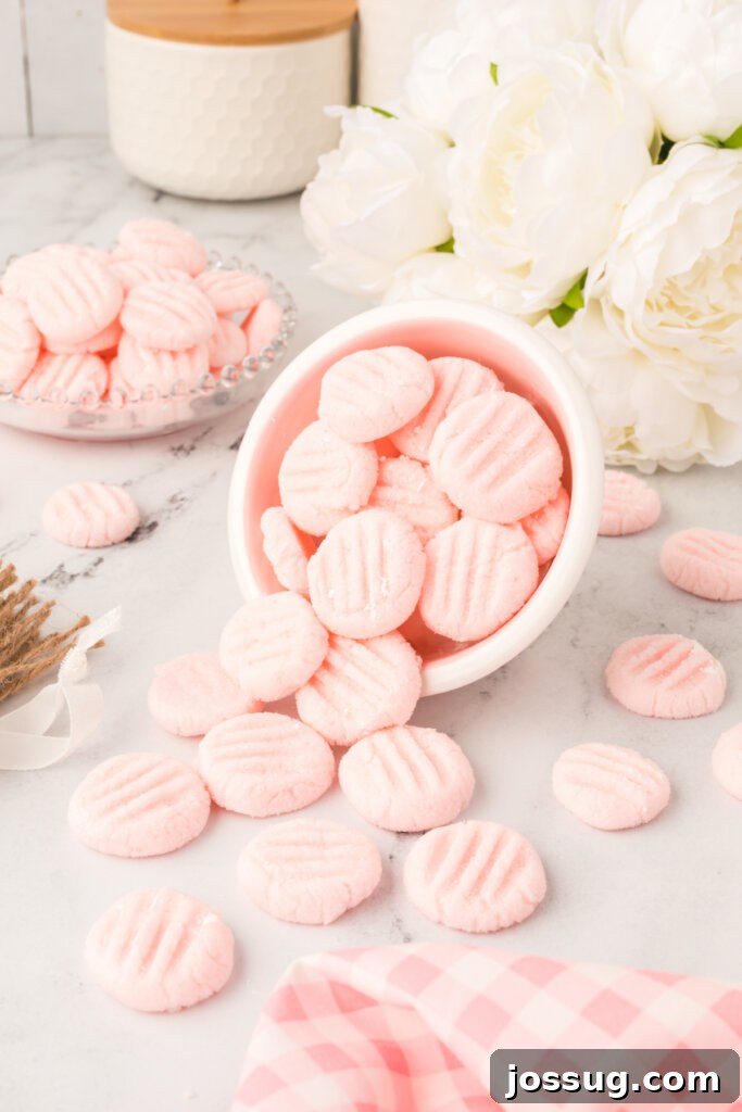 Velvet Mint Bites 5 A bowl filled with an abundance of perfectly shaped cream cheese mints, highlighting their appealing consistency and readiness to serve.