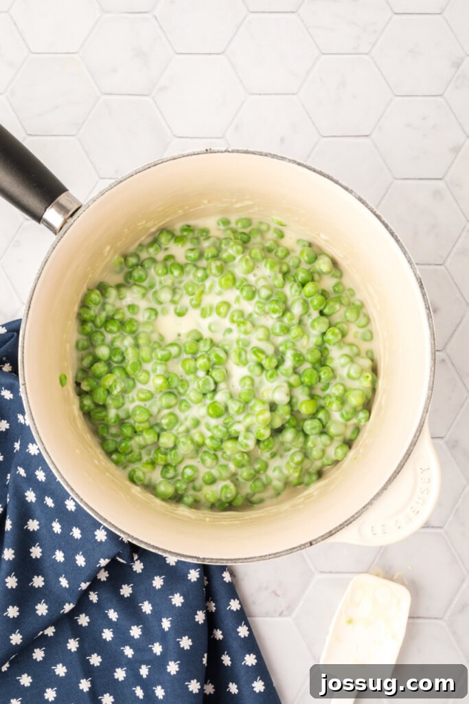 Velvet Peas 4 Creamed peas simmering in a saucepan, the sauce thickening
