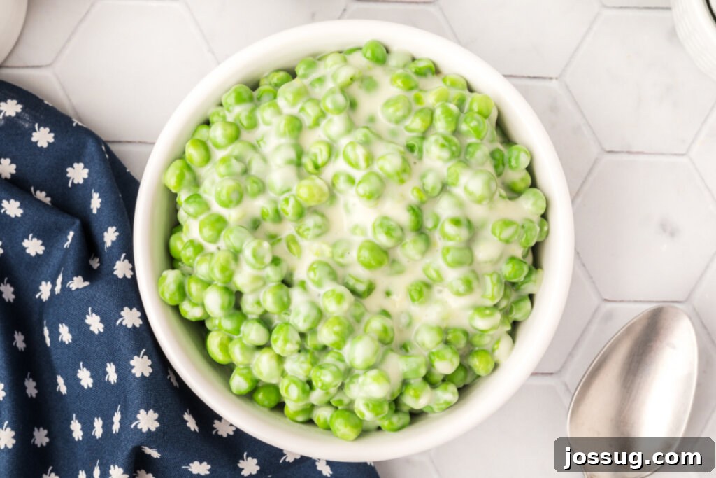 Velvet Peas 6 Overhead view of a bowl of creamed peas, garnished with fresh herbs